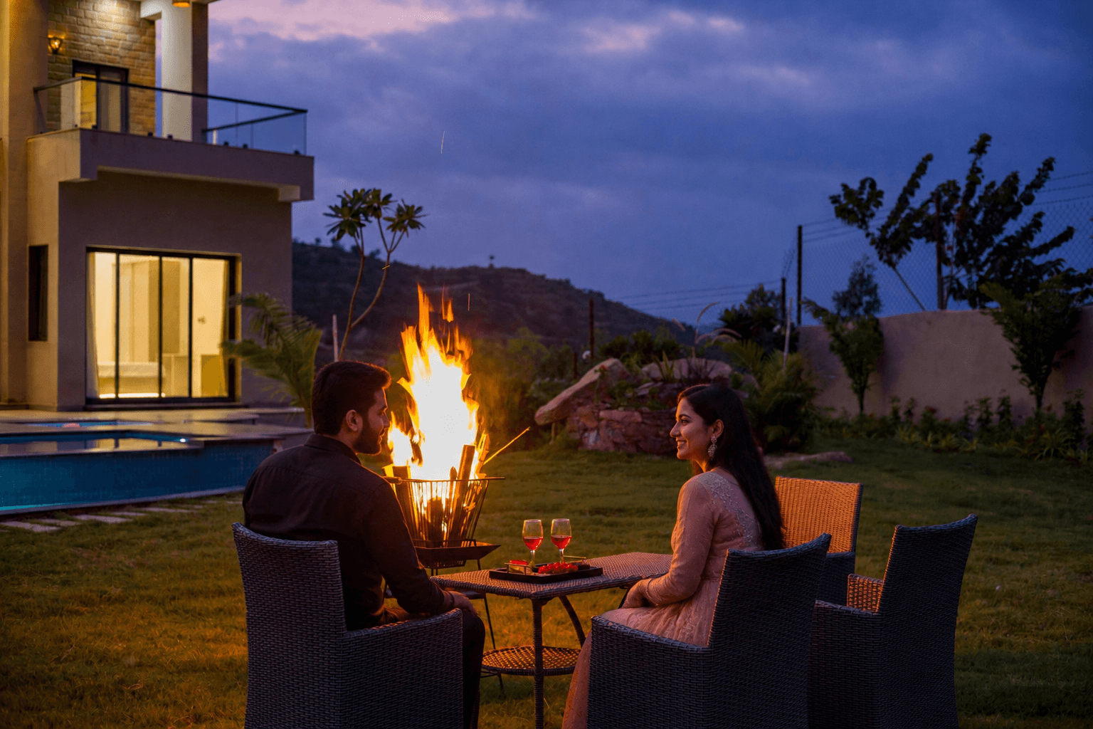 Couple enjoying a bonfire evening at an ImagesqueStay villa
